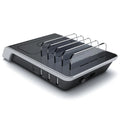Black universal mobile phone and tablet charging stand base on a desk