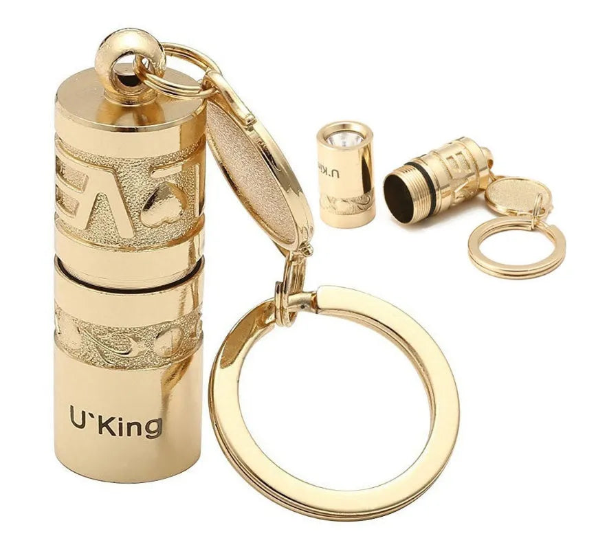 Gold-coloured zinc alloy mini portable LED flashlight on a keyring.