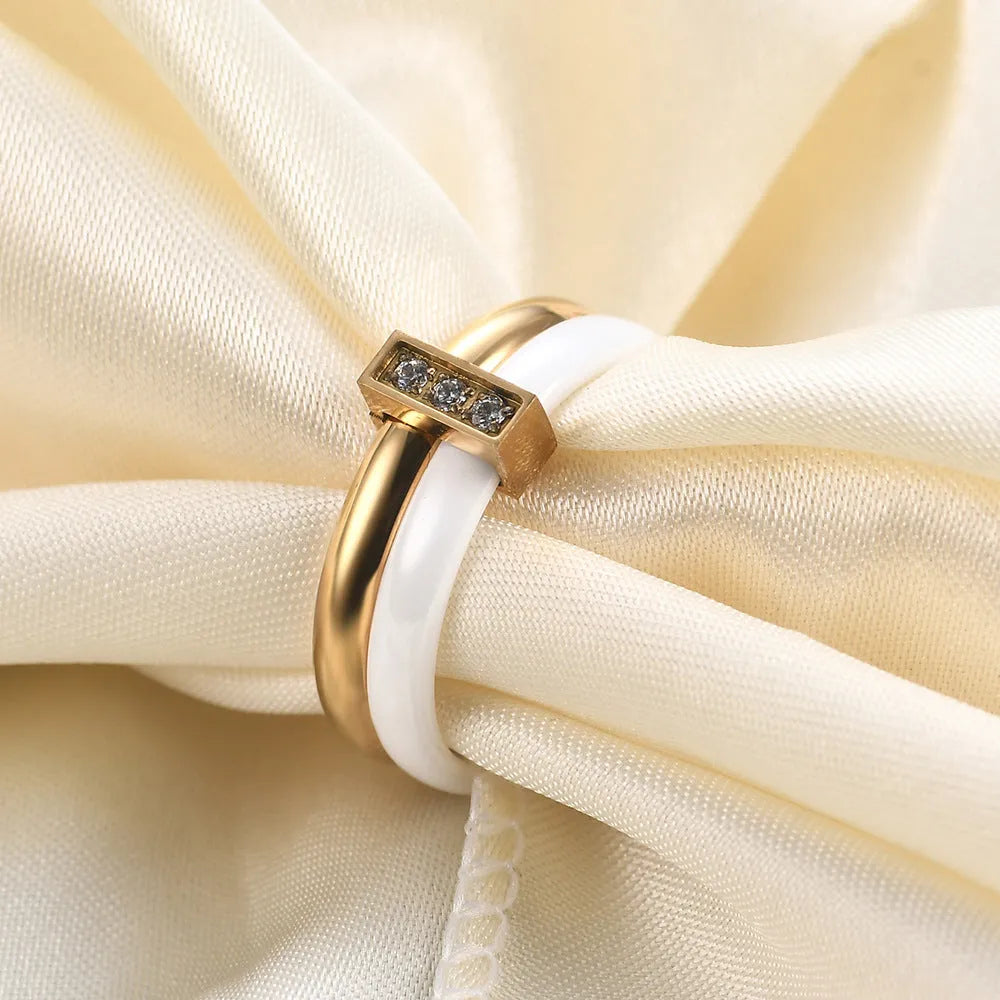 Geometric ceramic women's ring with glossy stitching and zirconium accents in steel black.
