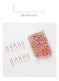 Rose gold heart-shaped paper clips with steel core construction measuring 28mm each