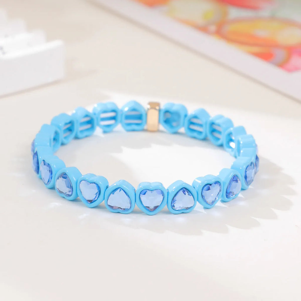 Rainbow coloured enamel heart pendant on stretch bracelet band
