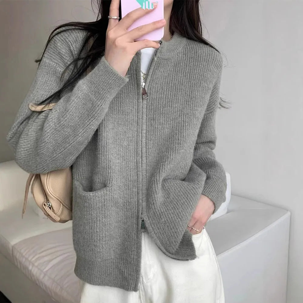 Beige viscose sweater coat cardigan with long sleeves on a hanger.