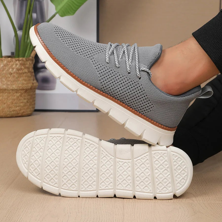 Men's grey and black casual sneakers with woven mesh upper and round toe.