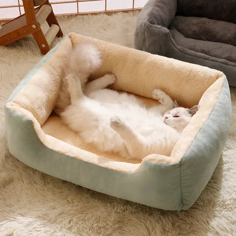 Soft short plush cat bed in grey, shown in a medium size for scale with a cat.