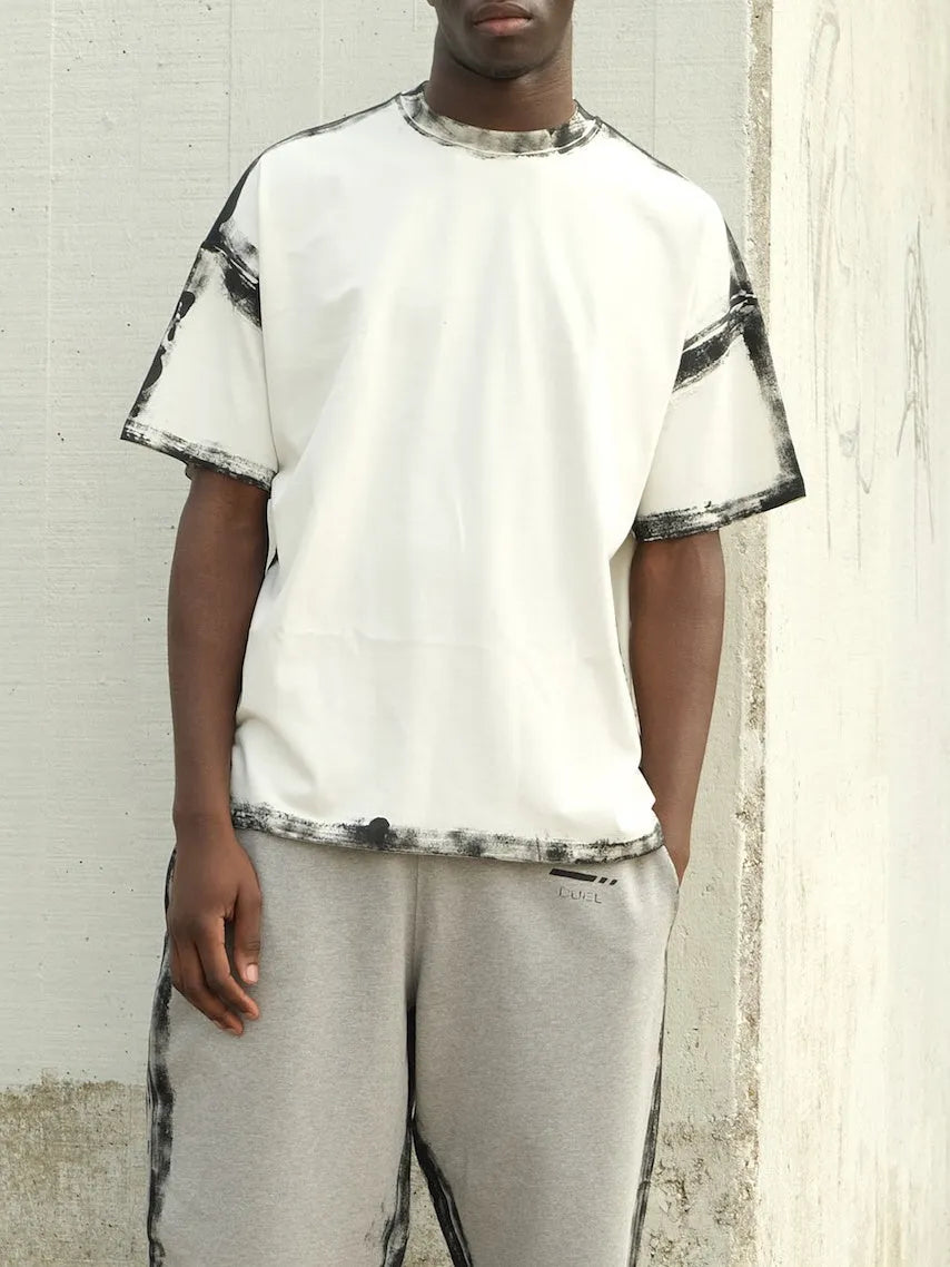 White casual short sleeve top with a draped design and printed detail.