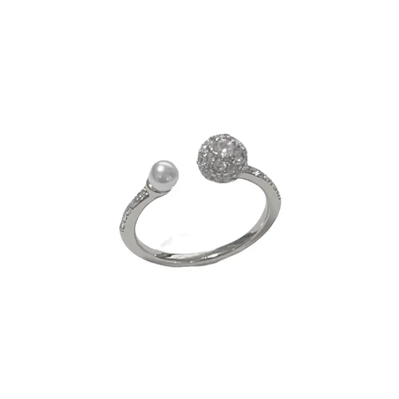 A simple geometric open-end ring with a round zircon stone, shown in gold and silver plated finishes.