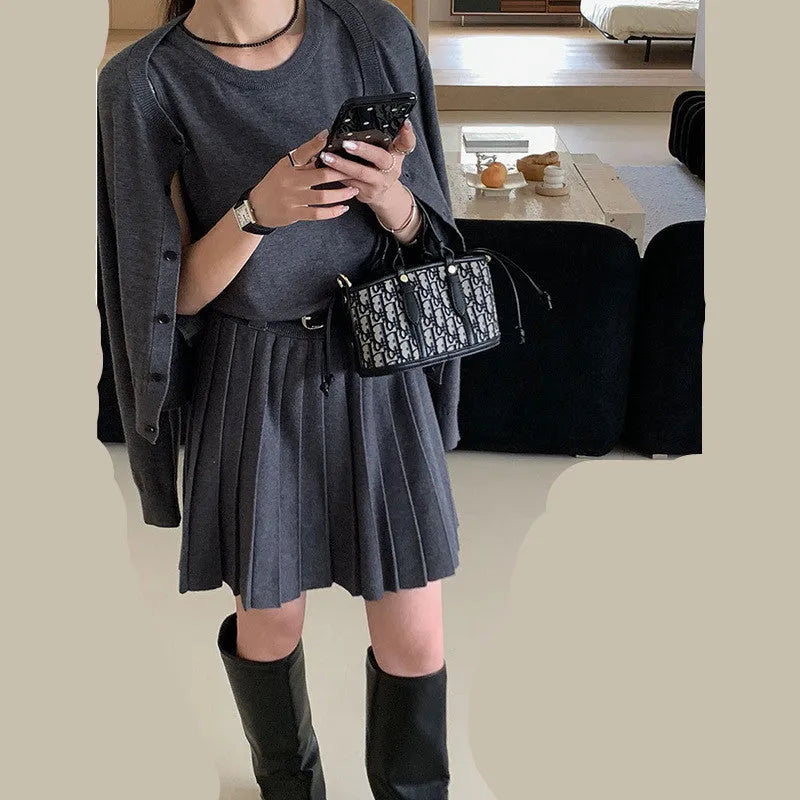 Grey women's knitted vest skirt and cardigan two-piece set with 3D pattern and belt.