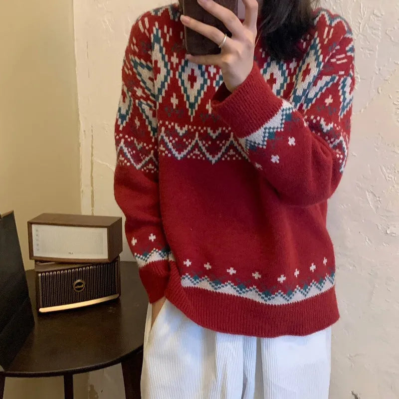 Red and white striped women's loose long-sleeve pullover knitted top on a hanger.