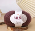 A ball of mohair yarn for a hand-woven DIY scarf kit, shown with a selection of its 34 colour options.