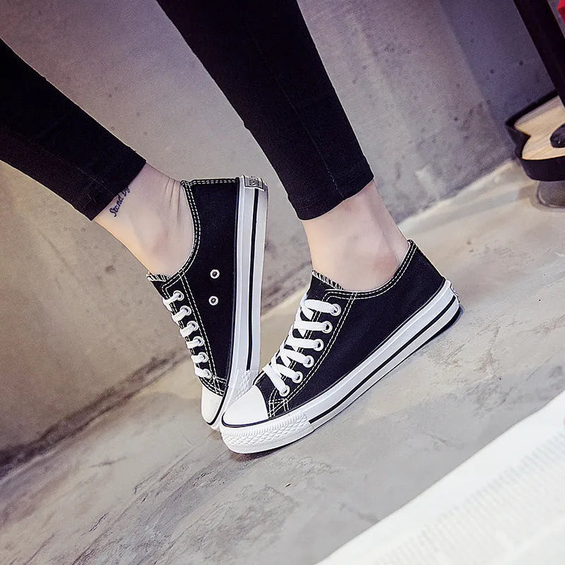 Women's casual canvas shoes in solid colours: all-black, black, white-black, and white-red.