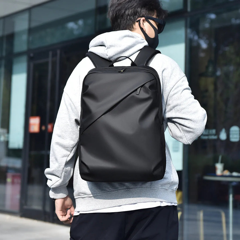 Waterproof PU leather backpack with laptop compartment in black, blue, and grey colour options