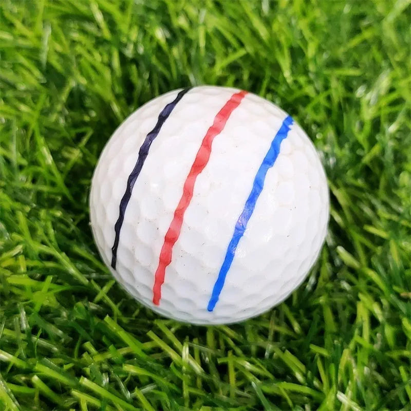 Golf putting alignment tool set with plastic scribers and drawing pens on a green.