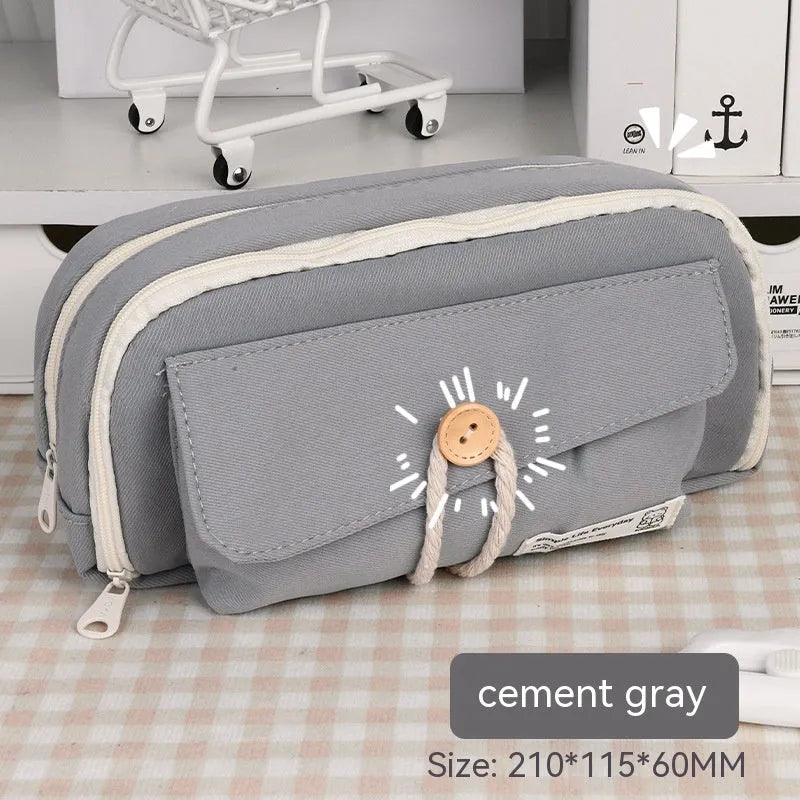 Large capacity canvas pencil case for girls in beige, blue, gray, or green, holding many pens.