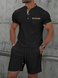 Men's grey zip-front polo collar tracksuit top and shorts set laid flat.