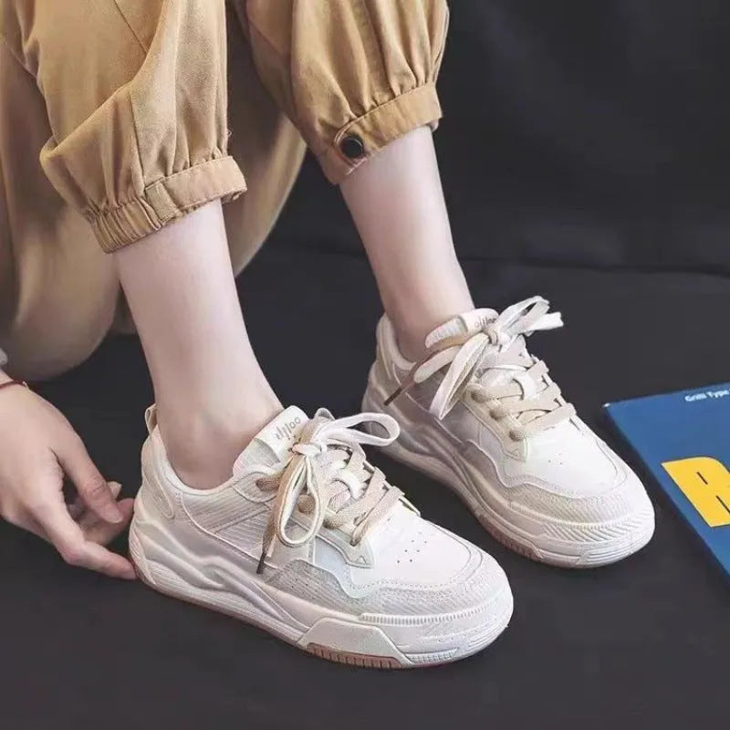 Women's beige and pink low-top rubber sole sneakers on a white background