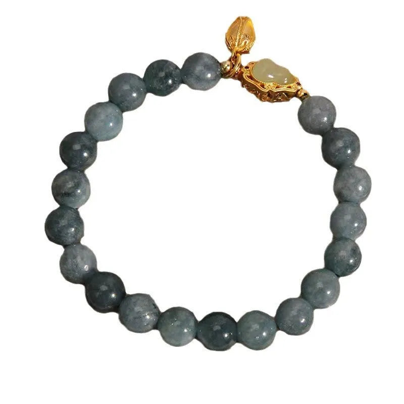 Natural stone bracelet with blue beads, lotus pendant, and adjustable leather strap