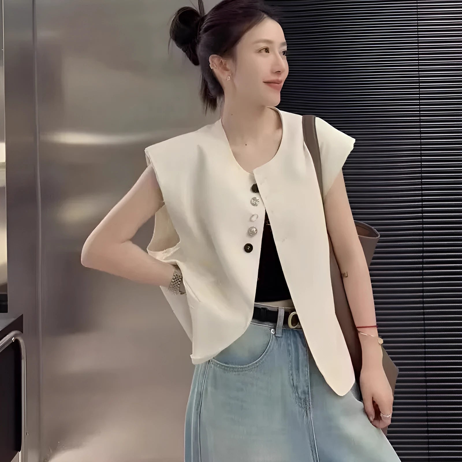 Women's loose fit solid colour polyester vest with pockets in milk white.