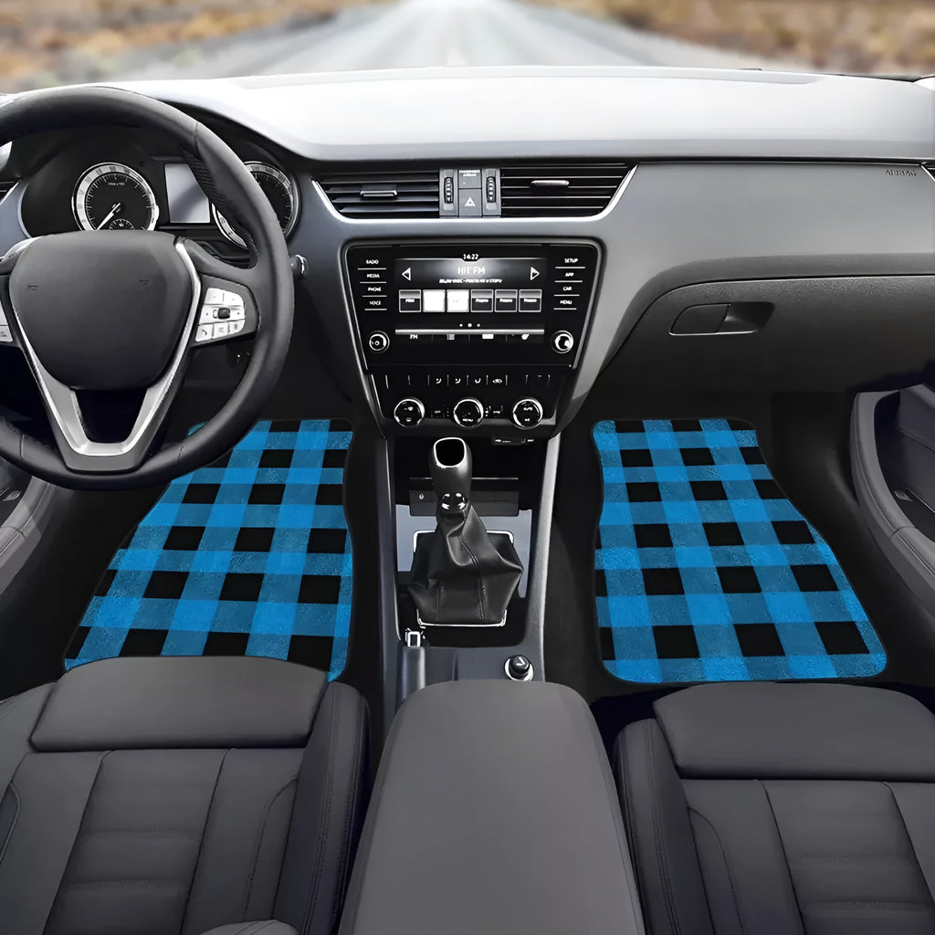 Set of four black printed rubber car floor mats with textured surface, showing thickness.