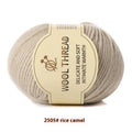 Roll of hand knitting wool yarn for baby clothes in assorted colours including green, beige, and red.