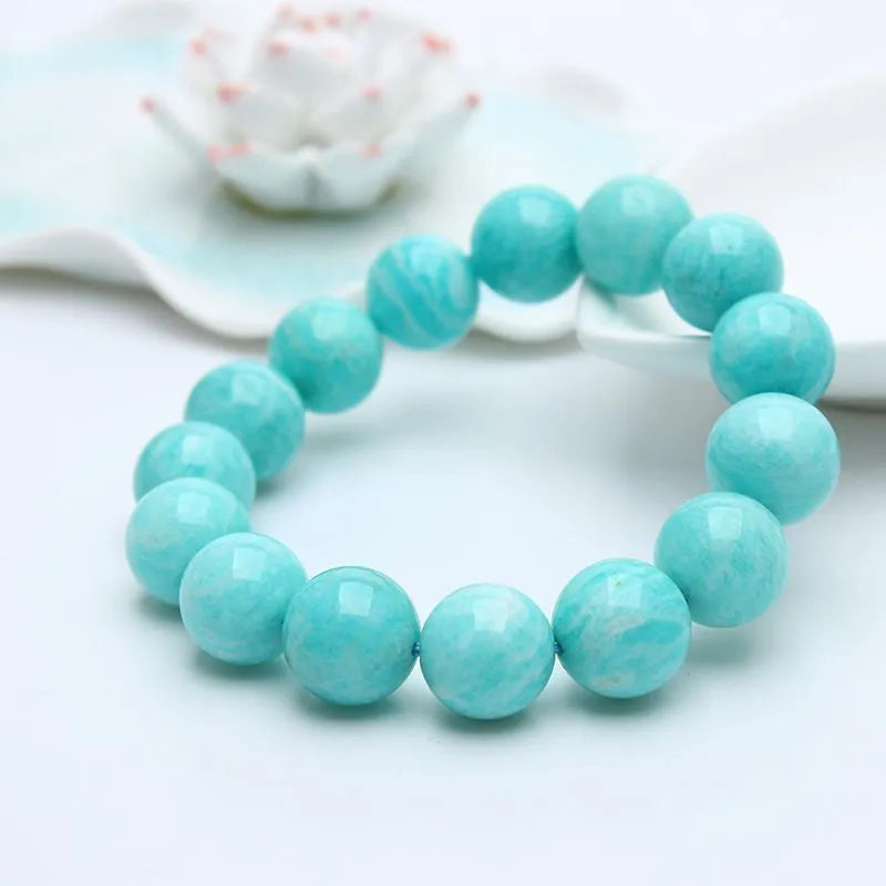 Blue-green amazonite stone beaded bracelet with adjustable string closure.