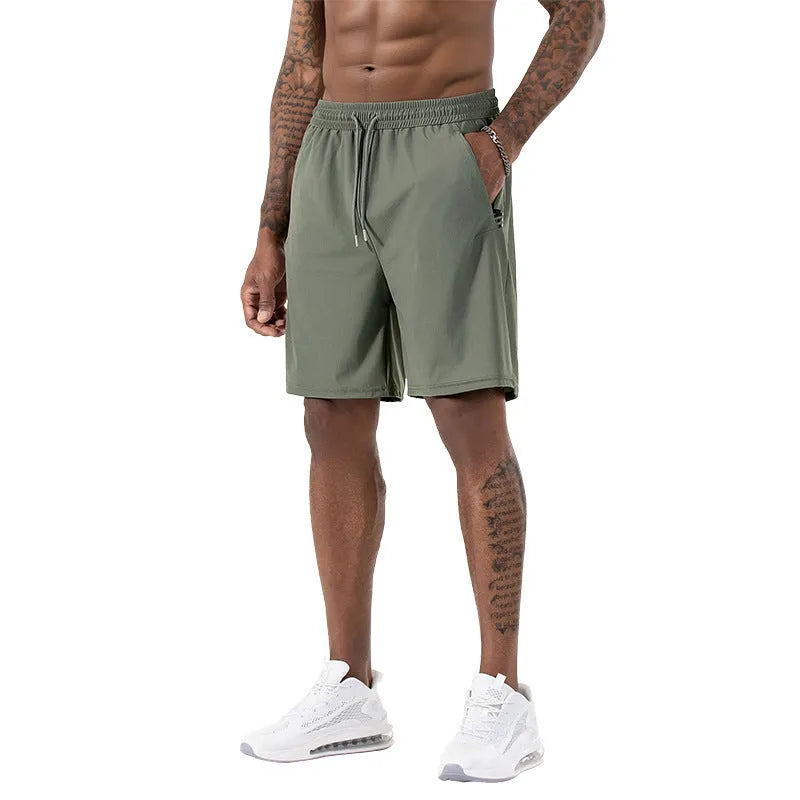 Man wearing black Ice Silk nylon sports shorts with a drawstring waist and cropped leg.
