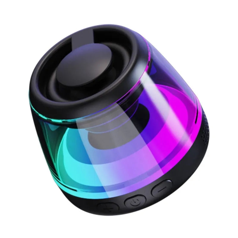 Black portable Bluetooth mini speaker with ambient light on a metallic surface, showing its magnetic base.