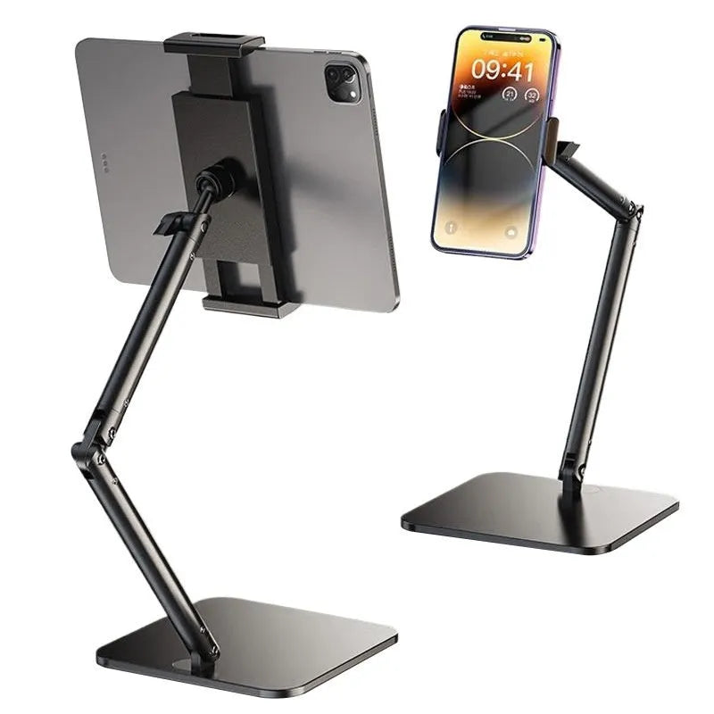 Silver alloy desktop phone bracket with double arms holding a smartphone, shown with a remote control on a wooden desk.