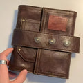 Brown retro buckle notebook with PU leather cover showing loose-leaf binder binding and A7 size format
