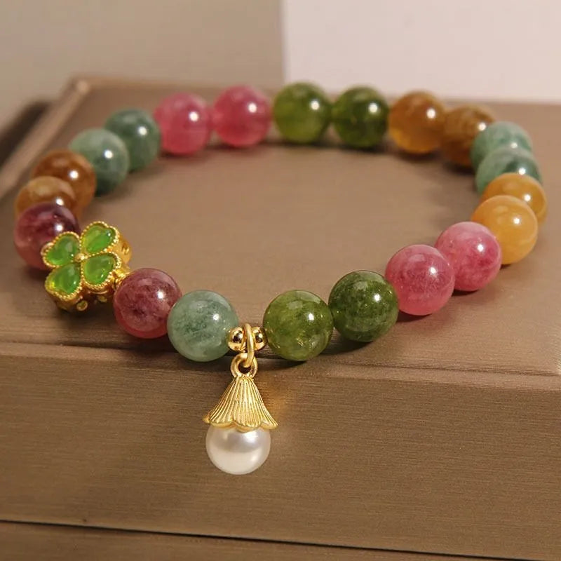 Women's colourful tourmaline bracelet with four-leaf clover charm and pearl pendant on a mixed material electroplated chain.