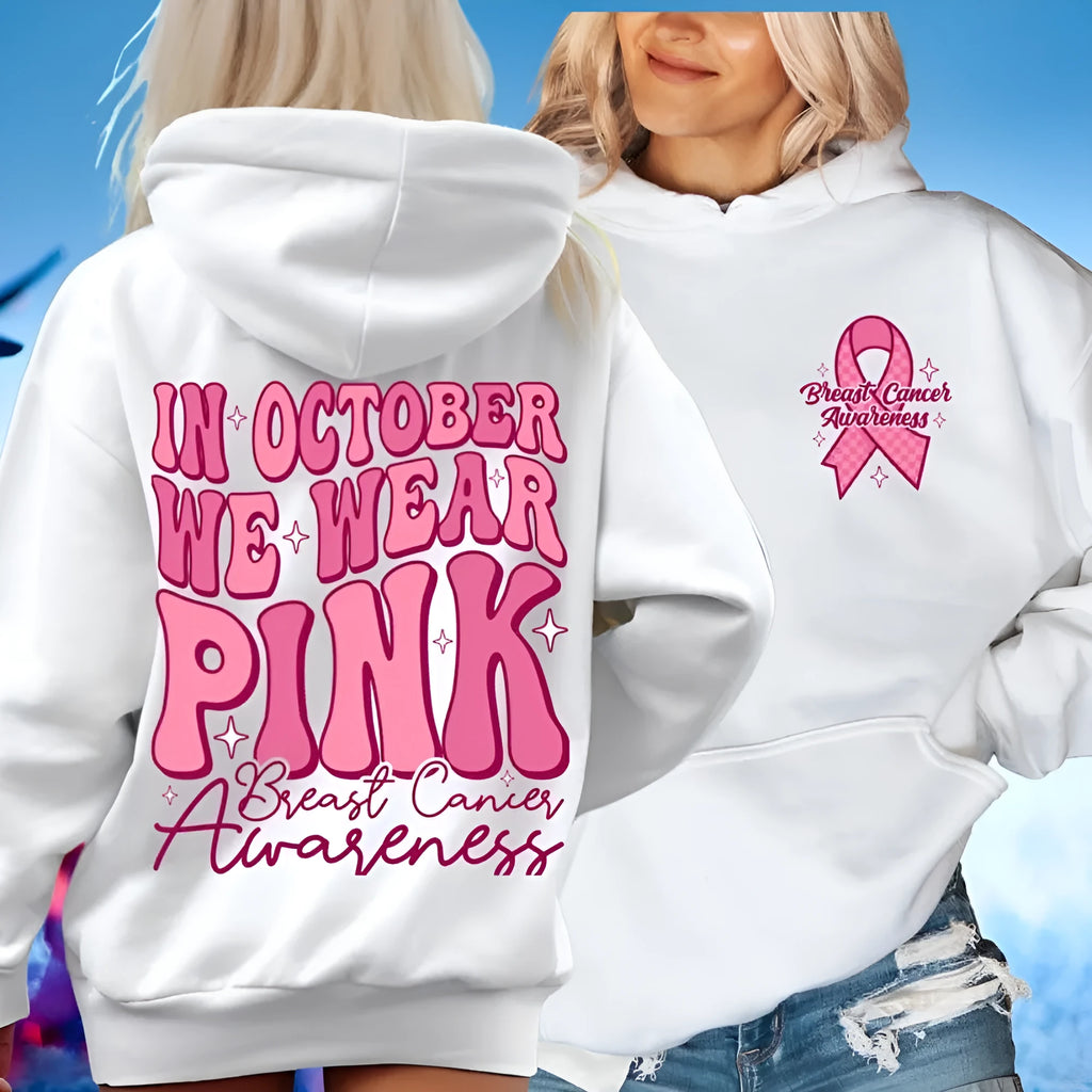 Pink breast cancer awareness hoodie with retro pattern and side pocket on a hanger.