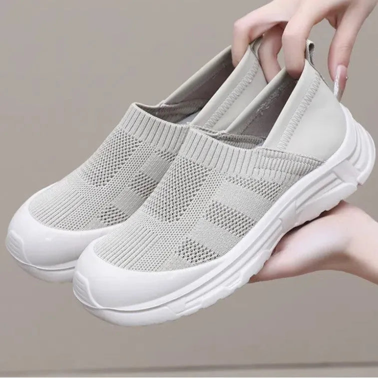 Women's black slip-on casual shoes with round toe and flat PVC sole.
