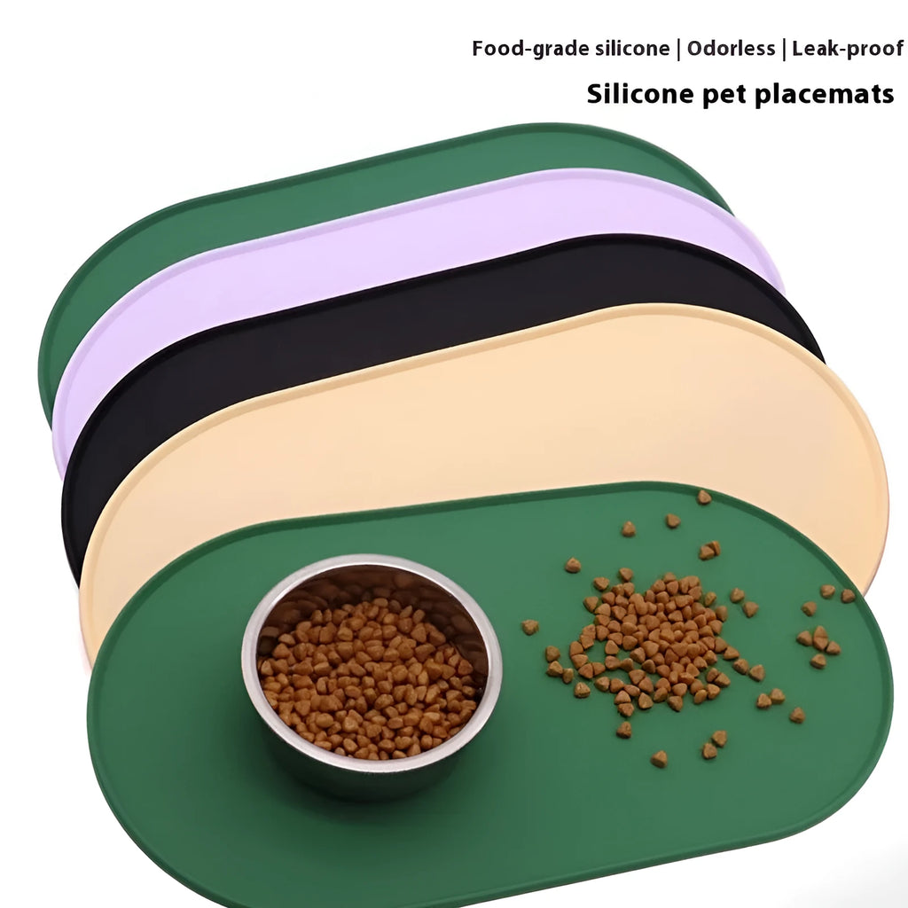 Green silicone waterproof placemat for cat food and water bowls on a floor.