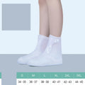 White PVC high-top reusable shoe covers for women, shown on feet.
