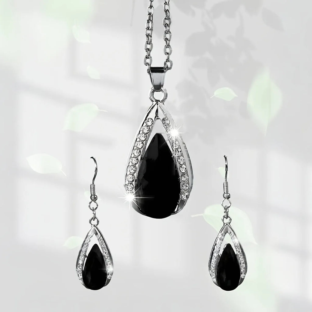 Black and red teardrop glass pendant necklace and matching earrings set on a white background.