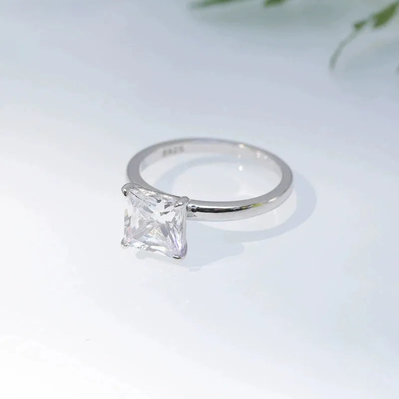A geometric 925 sterling silver ring with a round zirconium detail, shown in silver, gold, and rose gold colour options.