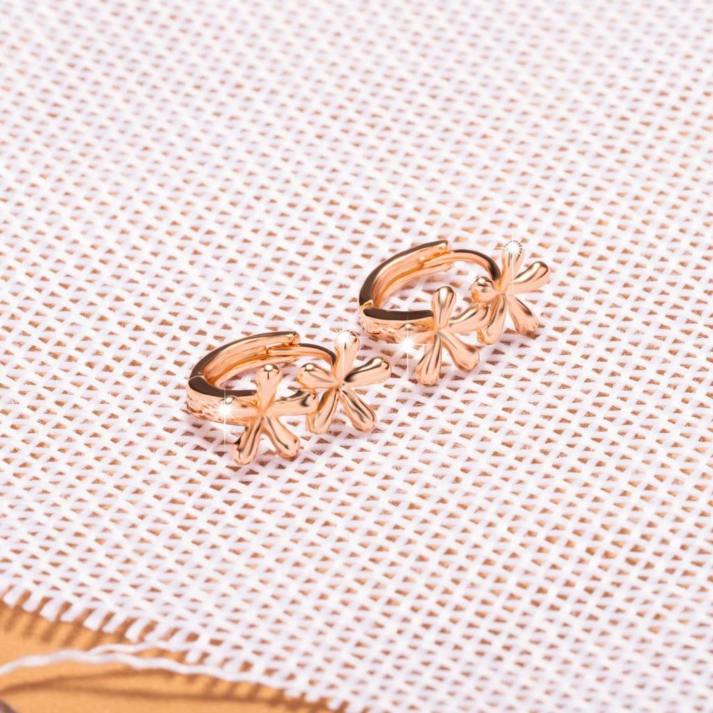 A pair of rose gold coloured waterdrop and circular shaped women's earrings on a white background.