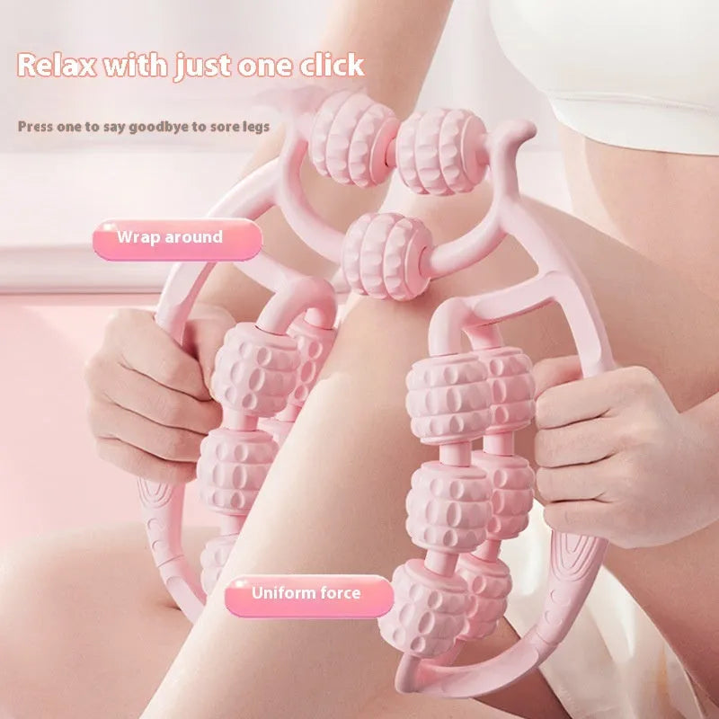 A handheld ring clip leg massage roller with double-row wheels, shown in coral pink.