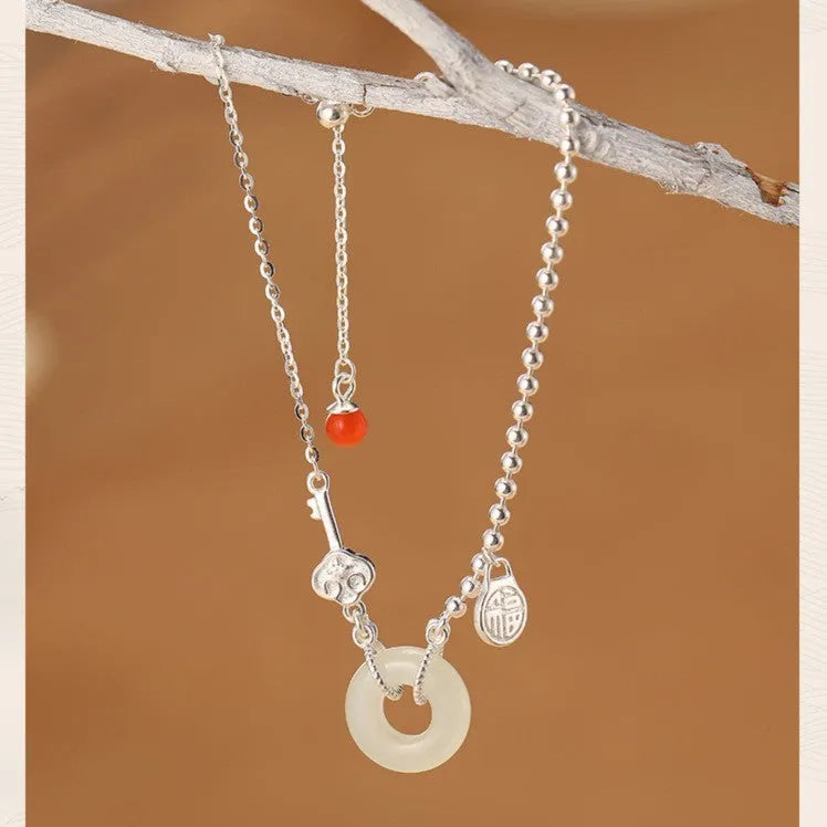 Silver Hetian jade bracelet with peace buckle charm and Chinese Ruyi Xiaofu design for women