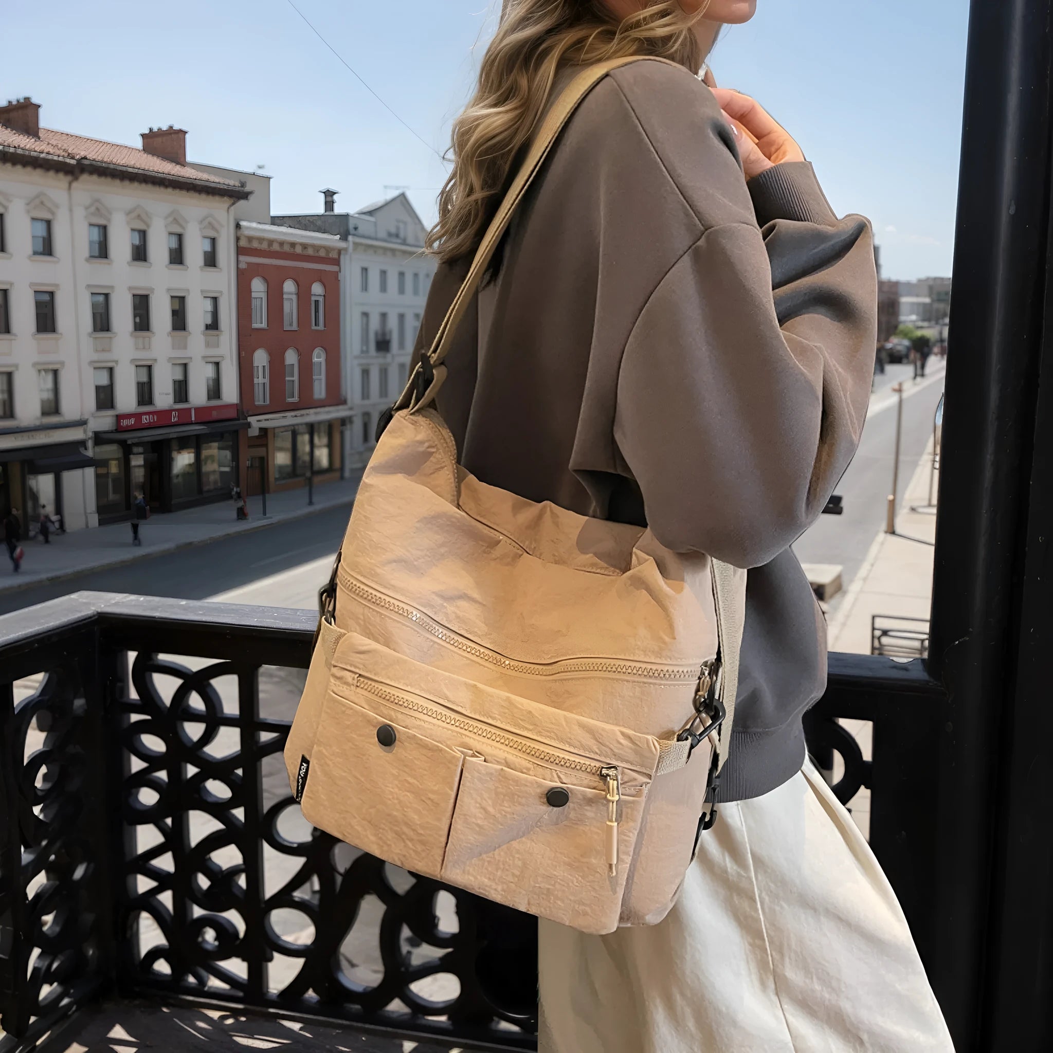 Women's nylon crossbody bag with double shoulder straps showing multiple pockets in black colour