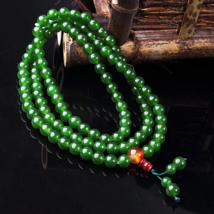 Green quartz rock jade rosary bracelet with 8mm beads and Buddha head design on wrist