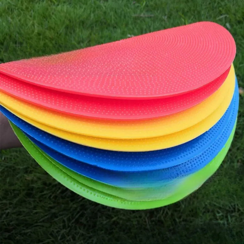 Multi-colour 23 cm diameter soft TPE football training target disc on grass