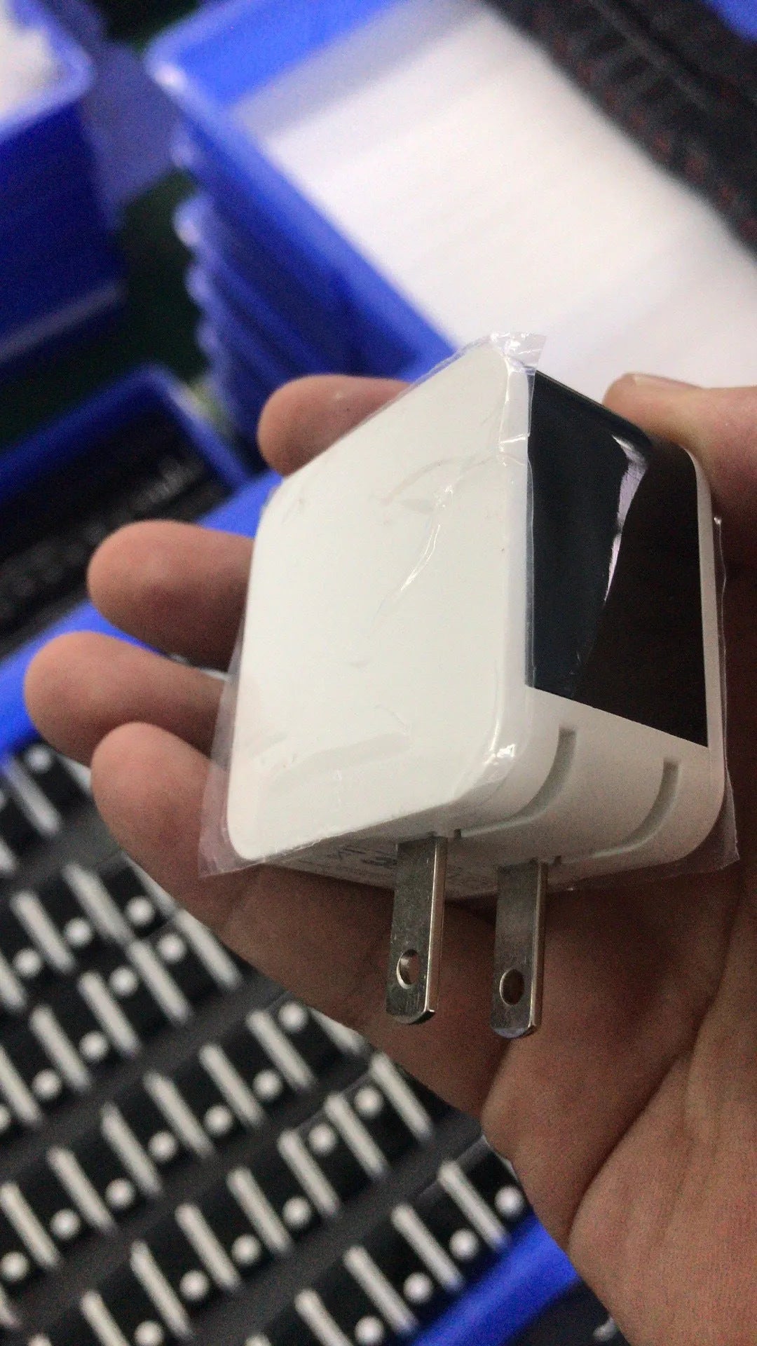 Black 5V 2.4A dual USB travel charger with digital display and a UK plug on a white background.