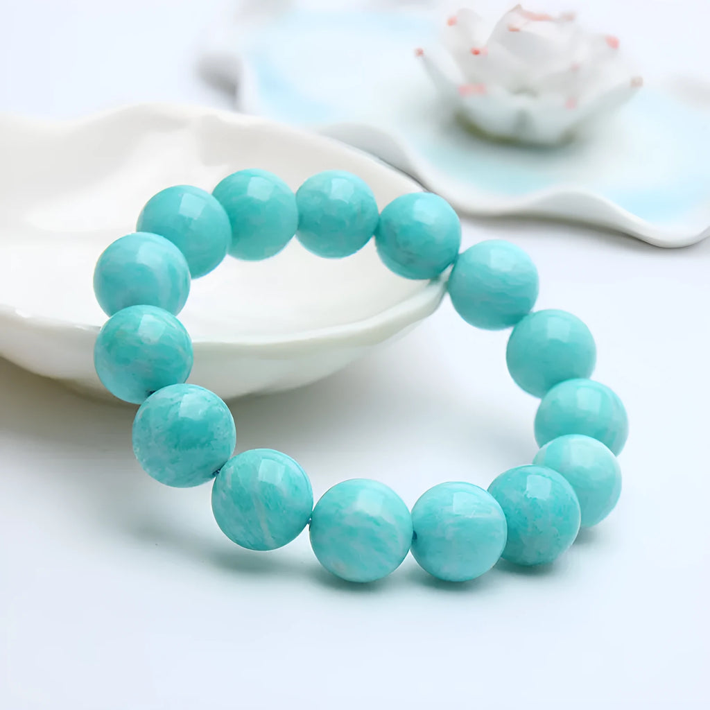 Blue-green amazonite stone beaded bracelet with adjustable string closure.