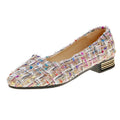 Women's black and white canvas flats with pointed toe and lace-up design