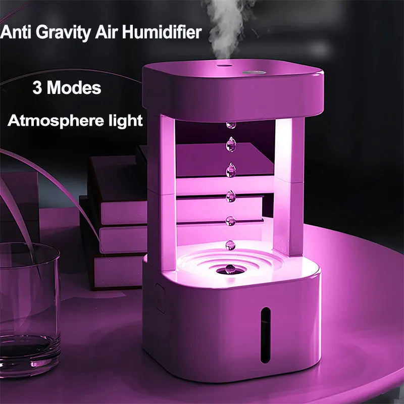 White anti-gravity water droplet USB humidifier with coloured lights on a desk