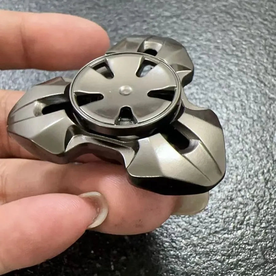 Metal alloy decompression toy with a rotating gyro, shown in gun colour and colourful options.