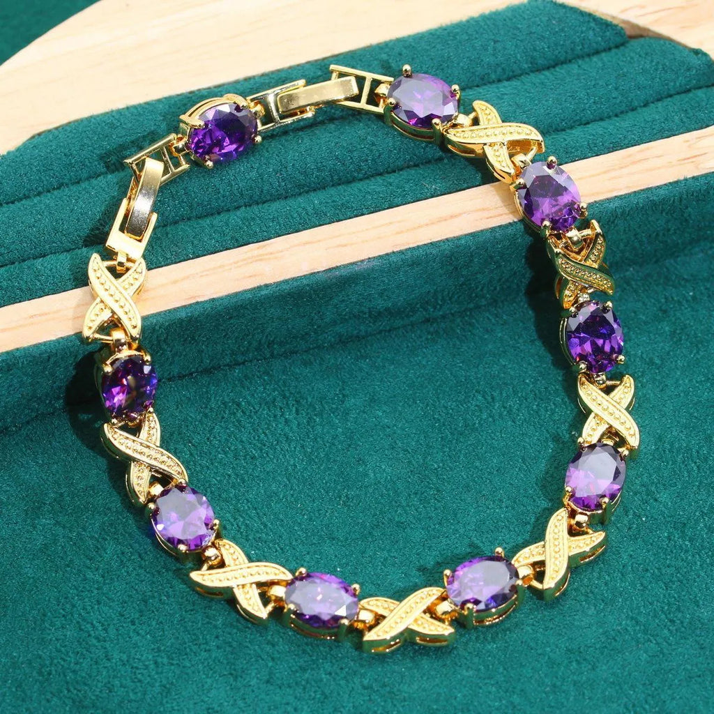 Gold plated zircon jewellery set showing necklace, earrings, ring, and bracelet with coloured cubic zirconia stones.