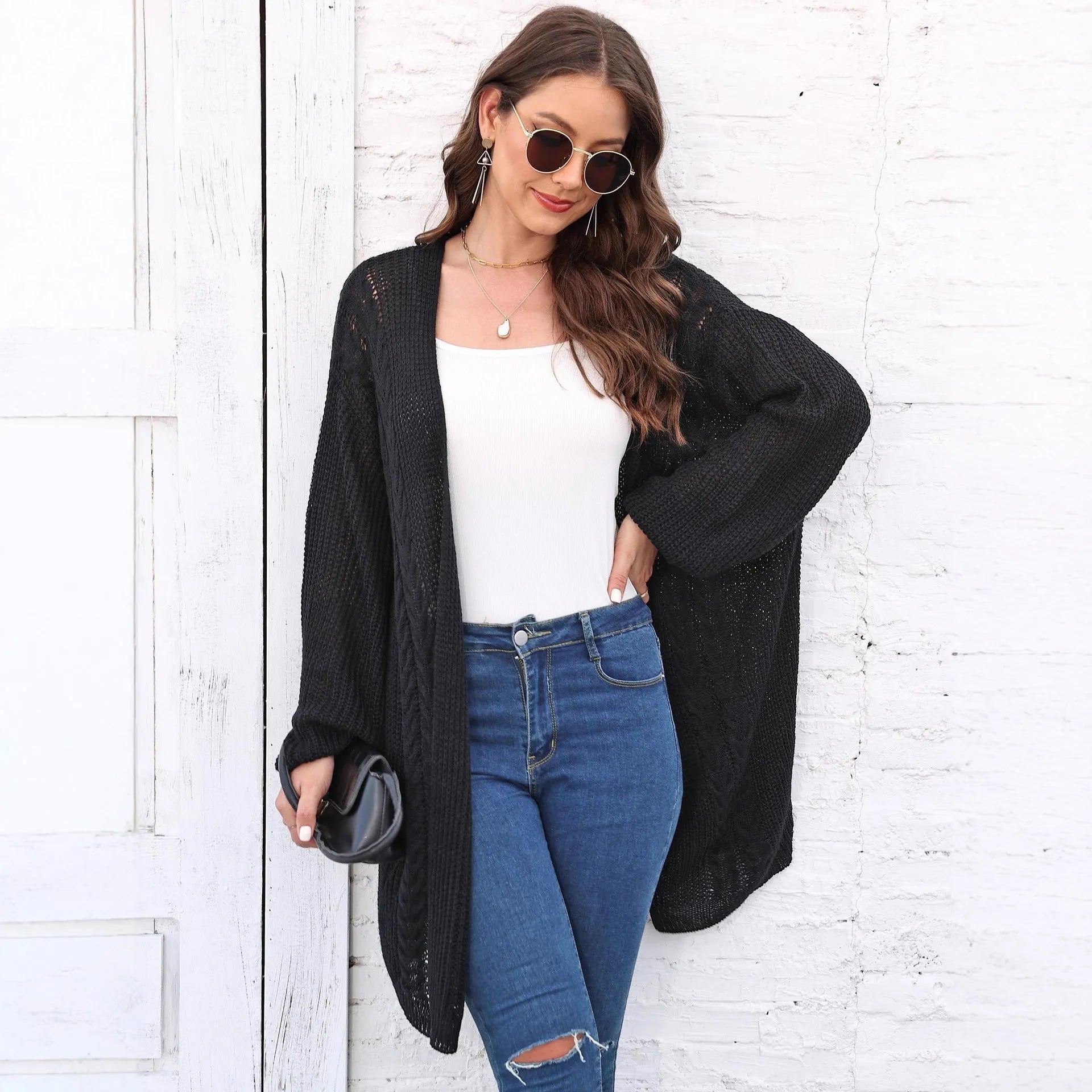 Women's loose-fit acrylic sweater coat in a solid colour, shown in light grey.