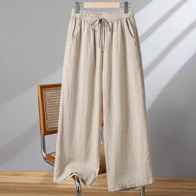 Women's apricot straight-leg casual trousers with elastic waist and front drawstring detail.