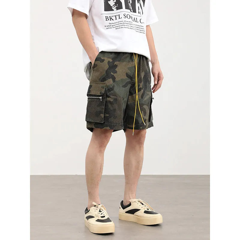 Men's camouflage cotton blend cargo shorts with multiple pockets, shown in a loose cropped fit.